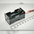 Black plastic 2x2 stacked AA holder; molded markings UM-2 and 1.5V AA visible; red and black lead wires attached; mounting holes on both ends.