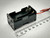 A compact 4 AA battery holder featuring spring terminals and two output leads (red and black). The holder is aligned next to a metric ruler, providing precise dimensions. Available at PartsMine.com.