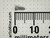 Macro of #0 screw beside millimeter ruler measuring about 5 mm overall length