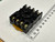 Angled view of Omron PF083A socket showing yellow DIN rail release clip and numbered terminals