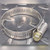 Single Breeze stainless hose clamp with gold-toned screw head, closed loop on diamond plate steel