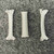 Three white braided sleeves with frayed cut ends on gray background