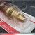 Angled close-up of brass-toned sealing lands and rounded seat nose in plastic