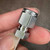 SS-300-R-2 reducer held in fingers, Swagelok and 316 stamping legible on nut face