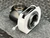 Three-quarter rear view showing threaded camera-side mounting ring and knurled shutter speed ring