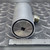 Opposite end face showing the recessed female square drive socket beside an inch ruler