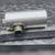 Full length side view of the transducer lying across an inch ruler, engraving visible