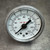 Close-up of the P1535 dial face showing 0 to 160 PSI and 0 to 11 BAR scales
