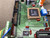 Close-up of SSQE SSQEXAO1PA-E silkscreen and socketed Philips PXAG49KBA microcontroller on green PCB