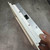 Angled side view of 3270091G chassis depth, mounting screws and slot exposing internal circuit board