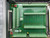 Green PCB with screw terminal rows, breadboard zones, and red DIP switch block visible. SCB-100 silkscreened near lower edge. CE mark present.