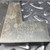 Second tip's stamped markings with orange corrosion running down its blade onto the base face.