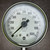 Close view of dial marked CONN-SST 316, TUBE-SST 316, WELDED, U.S. Gauge