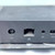 Rear panel with DC power jack, RJ-45 port, 3.5mm audio jack, and partial Mini DisplayPort visible. Top surface shows light swirl scratches.