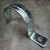 Zinc-plated metallic conduit strap, designed for 3-1/2 inch rigid or IMC conduit, featuring a curved push-on body and a single mounting hole on the flat base.