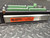 Campbell Scientific CR10X Measurement and Control Module featuring a silver metal housing with an orange identification sticker displaying "CR10X S/N X 25472," topped by a black detachable wiring panel populated with multiple rows of green screw terminal blocks.