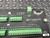 Close-up view of the Campbell Scientific CR10X Wiring Panel showing multiple green screw-terminal blocks for sensor inputs and control lines, a 9-pin female D-sub connector labeled "CS I/O," and a removable two-pin green terminal block for "G 12V POWER IN." The panel has white printed labels indicating various connections, including "SW 12V CTRL," "SDM," and "P1 G P2 G," along with the text "CR10X WIRING PANEL MADE IN USA.