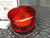 Red ribbed polycarbonate lens, black ABS base, two lead wires visible. Unit appears clean with no visible wear or damage.