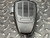Front face of EF Johnson palm microphone showing JOHNSON badge and slotted grille