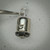 Sylvania 382 lamp held in tweezers, bright plated base shell showing part of the 382 marking