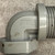 Close-up of elbow body with embossed marking one-half F2 and surface dirt