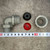 Overhead view of cord connector parts laid out beside a centimeter tape for scale