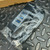 Angled view of bagged Inateck HBU3VL3-4 hub showing inateck wordmark, three blue USB 3.0 ports