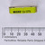 Yellow package edge printed MICRO 1/8 (273) above a millimeter ruler