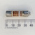 Cylindrical Bussmann Limitron KTK-R-4 Class CC fuse with silver ferrule ends and a tan body, displaying the printed text "Limitron® Class CC Current Limiting Symbol & Amp KTK-R-4" on a brown label, measured against a millimeter ruler backdrop.