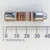 Class CC current-limiting fuse, model KTK-R-20, featuring a brown body tube and silver-colored metal end caps, positioned above a millimeter ruler for scale.