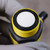 Ultrasonic sensor face showing clean white transducer and black rubber ring. Yellow threaded body has no visible damage.