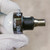 End view of four-pin male M12 connector with clean gold-colored pins and keyway.