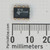 Texas Instruments NE555P DIP-8 top view, M745 marking and TI logo, millimeter ruler below