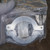 KF40 hinged clamp in clear plastic bag showing no visible damage or wear. Wing nut and hinge pins intact.