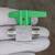 Green handle above valve body; partially legible code stamped across one body face.