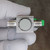 Bottom face of body with retaining ring around light colored disc, port stamped SWAGELOK.