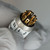 Terminal end view, clean gold-plated solder lugs ringing black insulator, numbered label edge visible