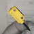 Banner photoelectric sensor showing clean yellow housing, "BANNER" logo, mounting holes, and intact pigtail cable.