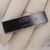 Gloved hand holds black 40-pin DIP marked P8039HL, L2158927, copyright INTEL 77.