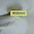 Yellow box body marked "100nK63" with Yageo tri-wing logo in blue; label clean, printing crisp, no discoloration or damage.