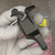 Close view of the latch clip mechanism, pivot screw, and spring on the adapter body.