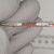 Glass-sealed axial resistor with red printed markings: MEGOHMS on black band, 10 and 2% visible. Code 492 printed vertically. Both end caps clear glass, no visible damage.
