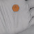 Orange ceramic disc body marked .022, Z5U, 600V with a small logo at top. Two straight radial leads, light surface scuffs on disc face.