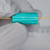 Teal cylindrical molded bobbin with markings EH1 and V4 visible; gold-plated axial leads extend from both ends. No damage observed.