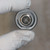 Face-on view of the 4-pin M12 Euro QD connector insert; gold contacts clean with no corrosion or bent pins visible.