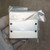 Machined aluminum manifold block with natural finish, four countersunk mounting holes on face, light surface scuffs visible on upper edge.