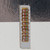 Ten axial-lead carbon composition resistors on a file card, brown bodies with orange-orange-yellow-silver color bands visible.
