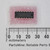 14-pin DIP plastic package, approximately 20mm long. Leads show visible tarnish. Two-line body stamp partially legible; pin-1 notch present.