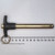 Gold-zinc plated shank approximately 120mm long with ball detent visible near tip; black T-handle with stamped text partially legible; brass ring attached.