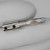 Nickel-finish solderless banana plug with spring-tine tip, clear insulating nose cap, and two side-mounted Allen screw holes on the barrel.